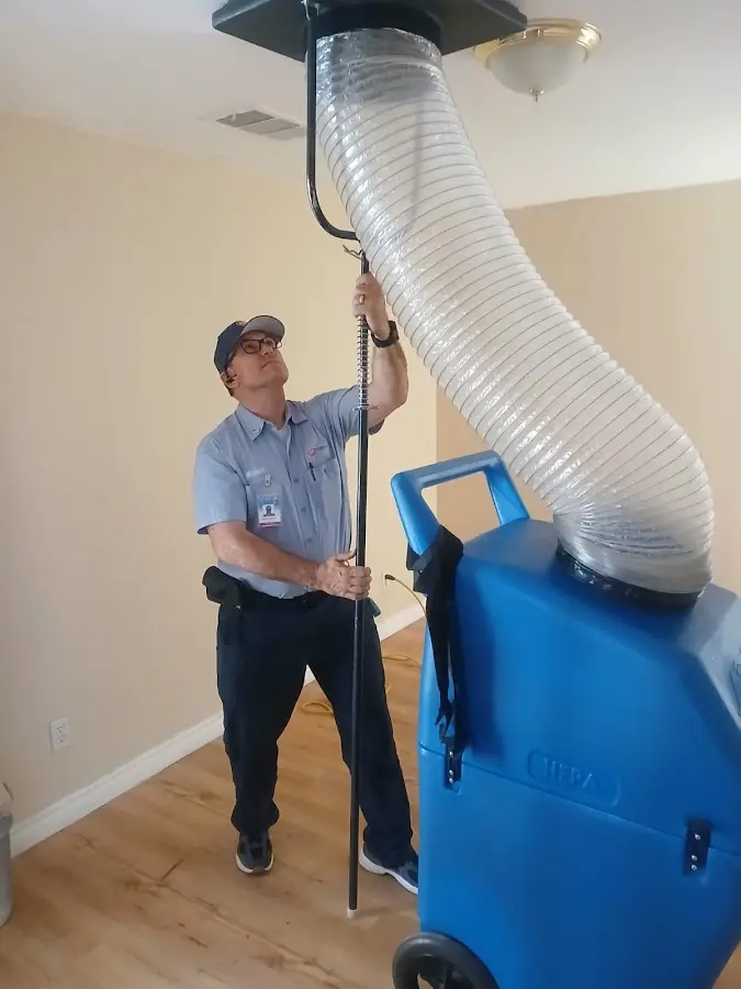 Furnace Tune-Up technician using HEPA equipment in Fridley